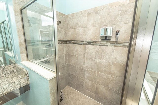 bathroom with a tile shower