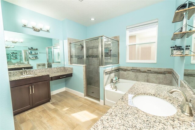 bathroom featuring vanity and plus walk in shower