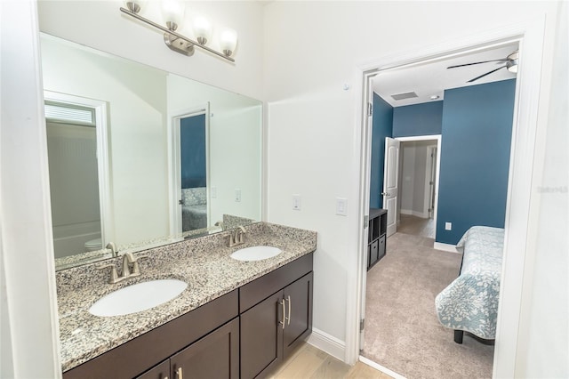 bathroom featuring vanity, toilet, and ceiling fan