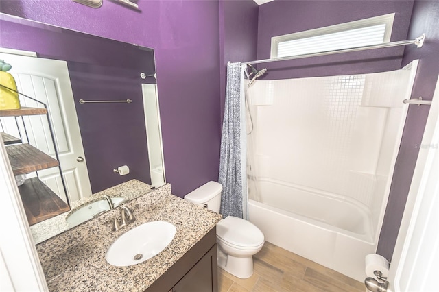 full bathroom with vanity, hardwood / wood-style floors, shower / bath combination with curtain, and toilet