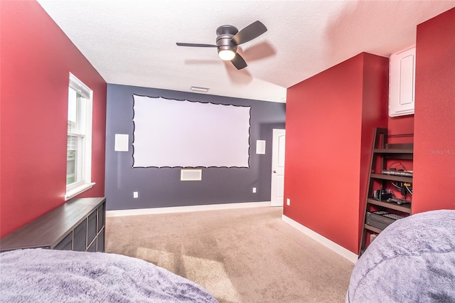 carpeted cinema with ceiling fan, a textured ceiling, and lofted ceiling