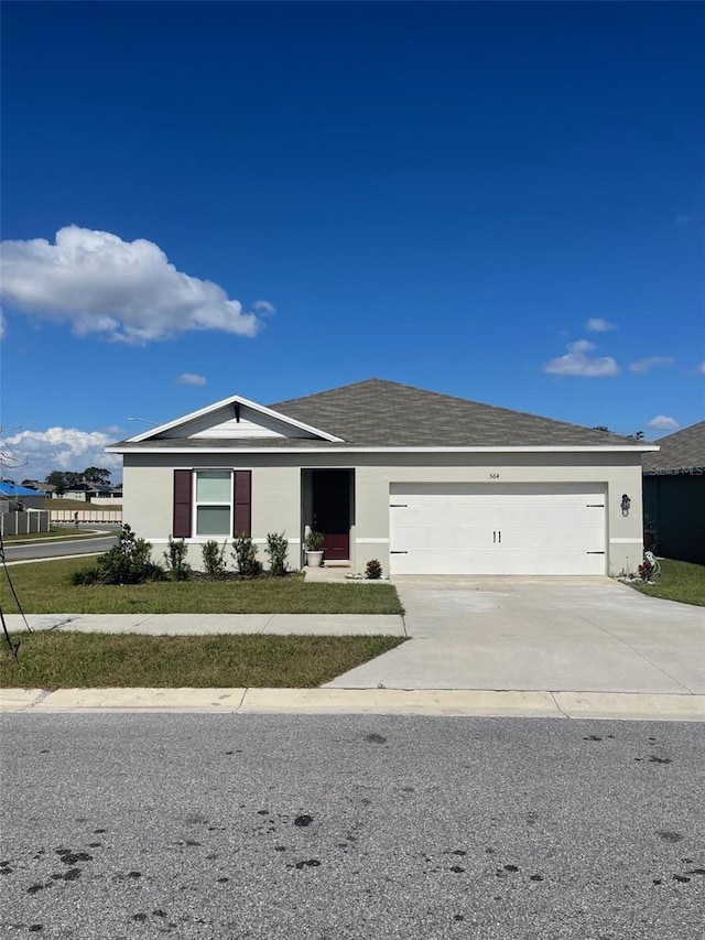 564 Boardwalk Ave, Haines City, FL 33844 - single story home featuring an attached garage, concrete driveway, and stucco siding