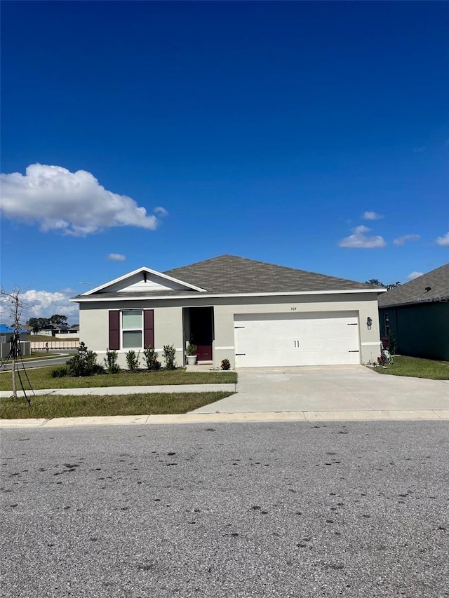 564 Boardwalk Ave, Haines City, FL 33844 - single story home with a garage, driveway, and stucco siding