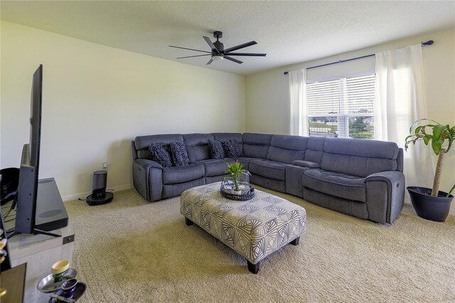 carpeted living room with a textured ceiling and ceiling fan