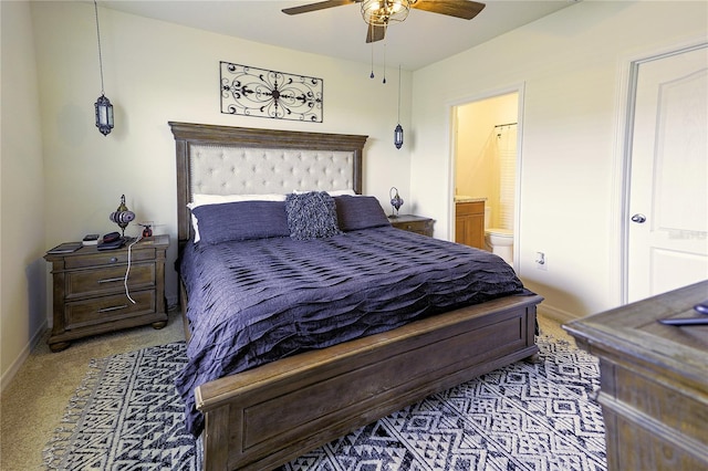 bedroom with carpet, ceiling fan, and ensuite bathroom