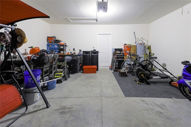 garage with water heater and a garage door opener