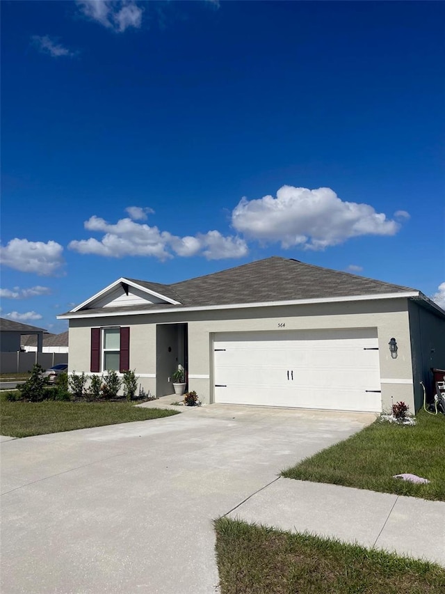 ranch-style house with a garage and a front lawn