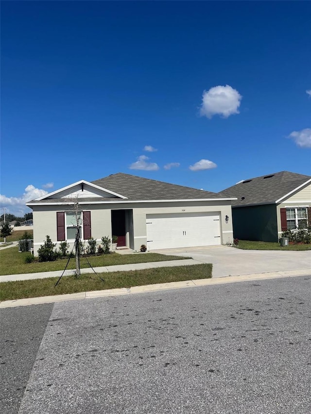 564 Boardwalk Ave, Haines City, FL 33844 - ranch-style house with an attached garage, driveway, and stucco siding