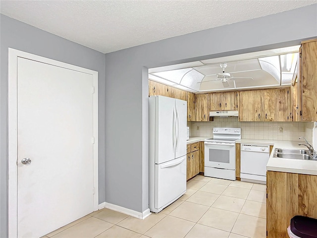 kitchen featuring tasteful backsplash, ceiling fan, a textured ceiling, sink, and white appliances