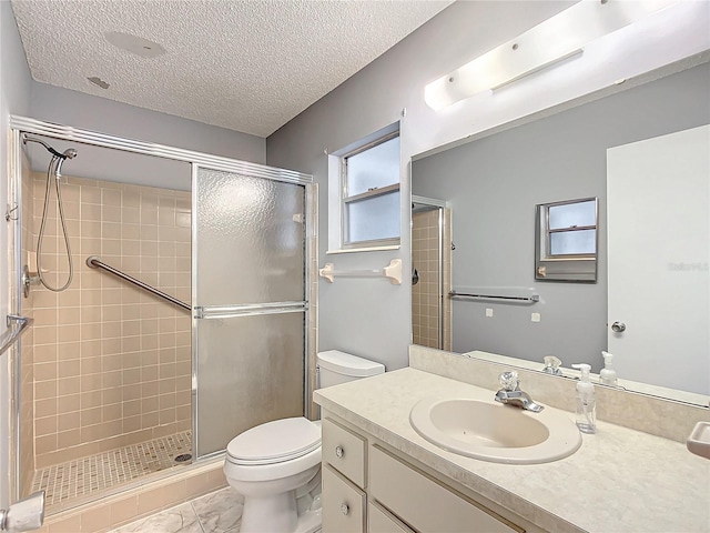 bathroom with toilet, a textured ceiling, walk in shower, and vanity