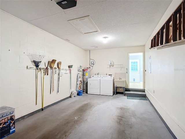 garage featuring a garage door opener, washer and dryer, electric water heater, and sink