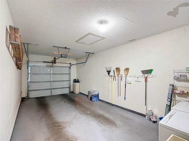 garage with a garage door opener and washer and clothes dryer