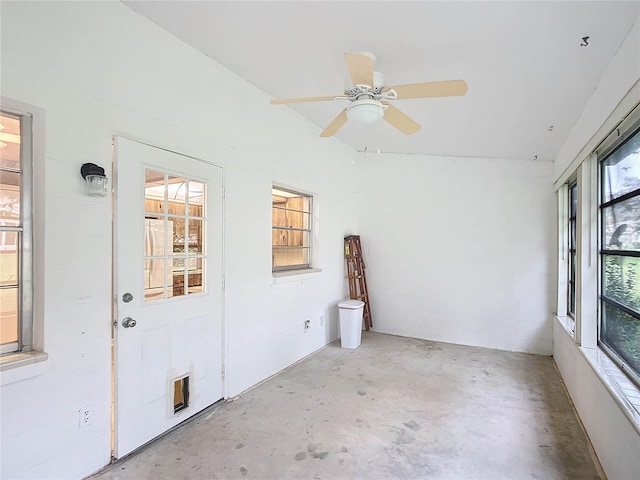 unfurnished sunroom featuring ceiling fan