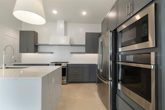 kitchen featuring sink, gray cabinets, stainless steel appliances, light tile patterned flooring, and wall chimney exhaust hood