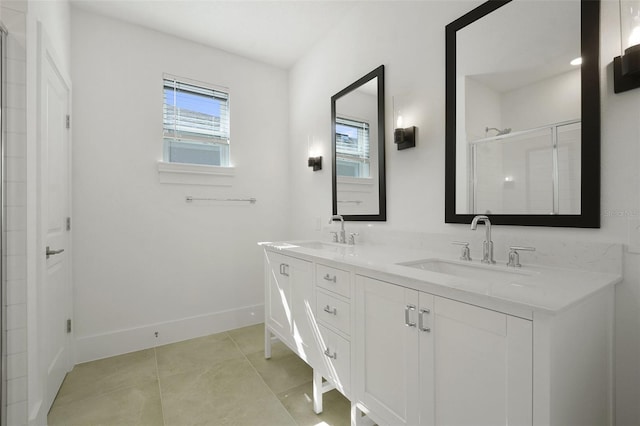 bathroom featuring tile patterned flooring, vanity, and walk in shower