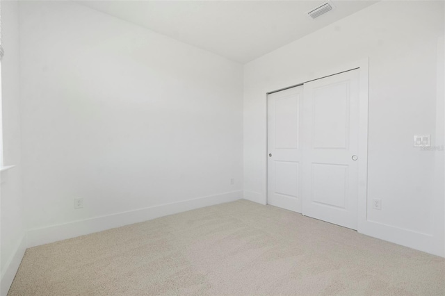 unfurnished bedroom featuring carpet floors and a closet