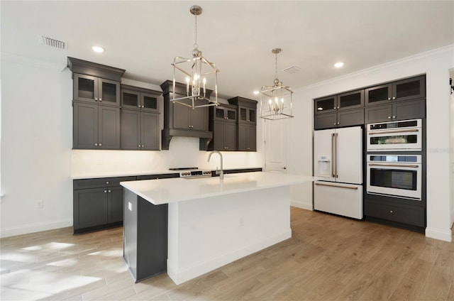 kitchen featuring visible vents, light wood-style flooring, white appliances, an inviting chandelier, and light countertops