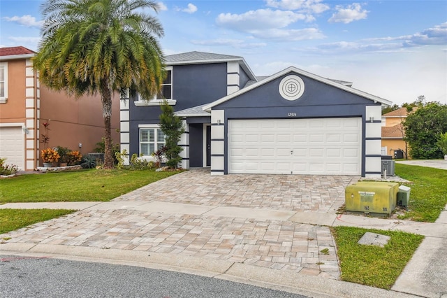 view of front of home with a front yard and a garage