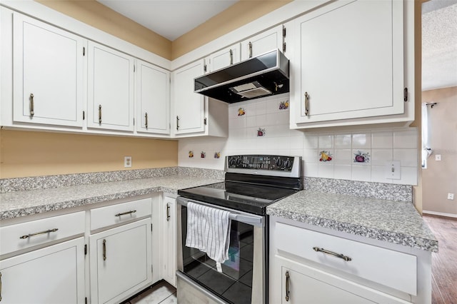 kitchen with white cabinetry, electric stove, tasteful backsplash, and light wood-type flooring