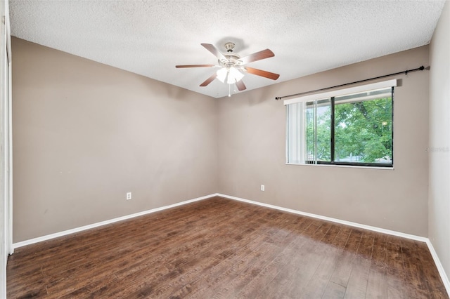 spare room featuring a textured ceiling, dark wood-type flooring, and ceiling fan