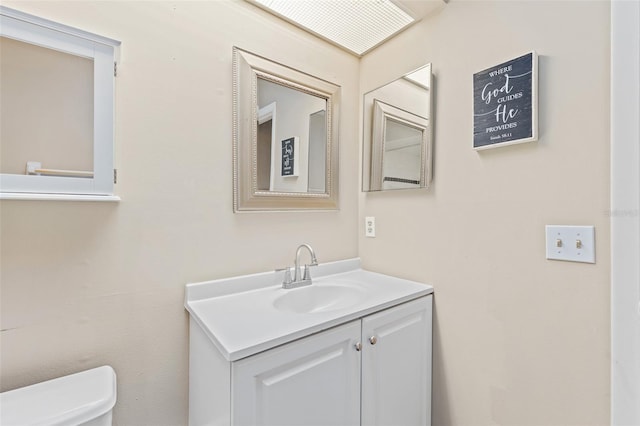 bathroom featuring toilet and vanity