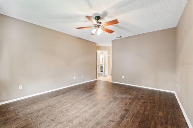 unfurnished room featuring dark wood-type flooring, a textured ceiling, and ceiling fan