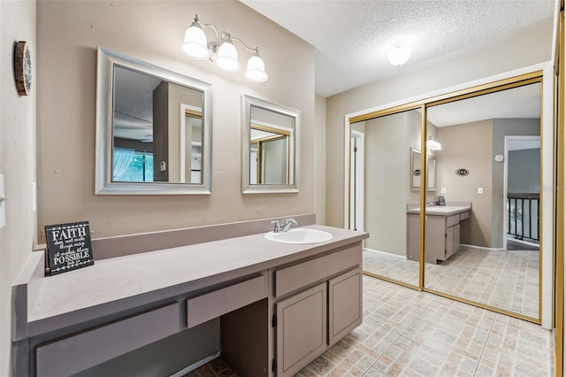 bathroom featuring vanity and a textured ceiling