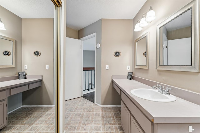 bathroom featuring vanity and a textured ceiling