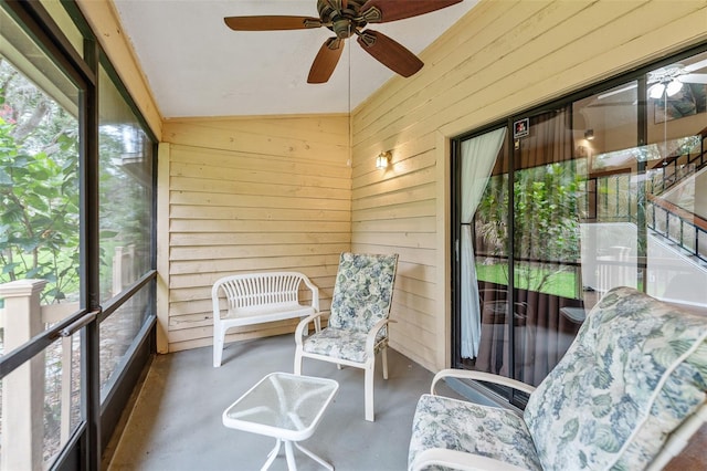 sunroom / solarium with ceiling fan and vaulted ceiling