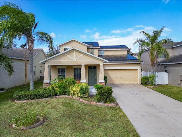 view of front of property with a garage, a front lawn, and solar panels