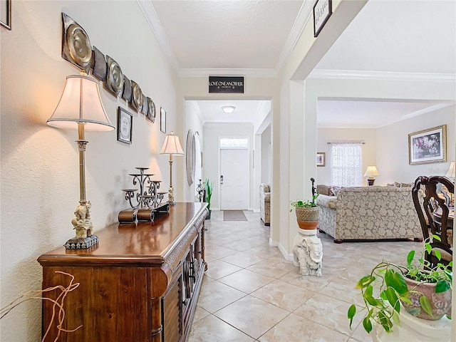 tiled foyer featuring crown molding