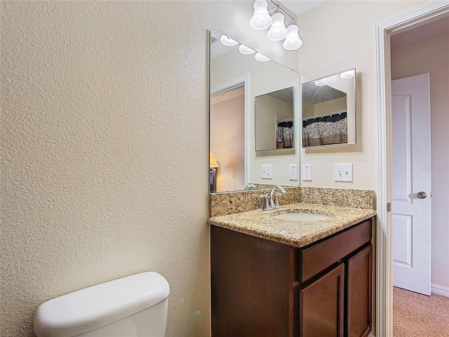 bathroom with toilet and vanity