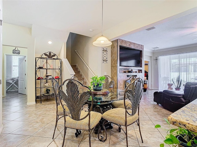 tiled dining space featuring plenty of natural light