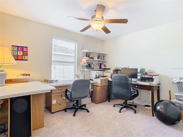 carpeted office space featuring ceiling fan