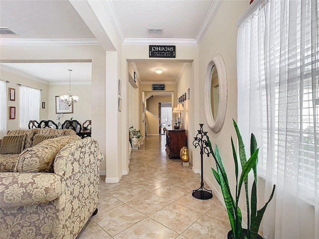 corridor with crown molding, an inviting chandelier, and light tile patterned floors