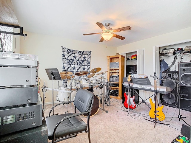 carpeted home office featuring ceiling fan