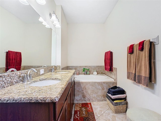 bathroom with vanity, tiled tub, and tile patterned floors