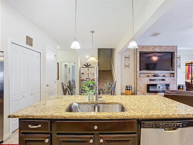 kitchen featuring decorative backsplash, stainless steel dishwasher, dark brown cabinets, and pendant lighting