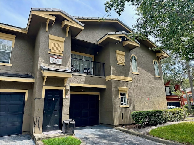 view of front facade with a balcony and a garage