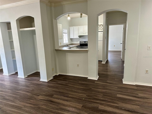 kitchen featuring dark hardwood / wood-style floors, kitchen peninsula, ornamental molding, stainless steel electric range, and white cabinets