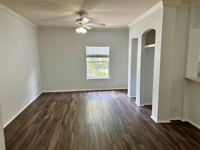 empty room with crown molding, dark wood-type flooring, and ceiling fan