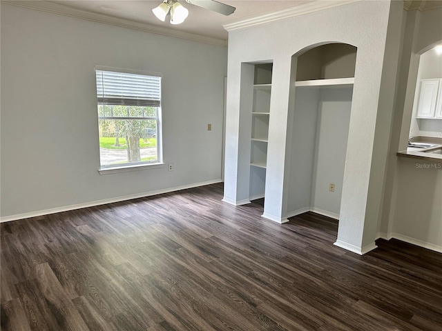 unfurnished bedroom with dark hardwood / wood-style flooring, ornamental molding, and ceiling fan