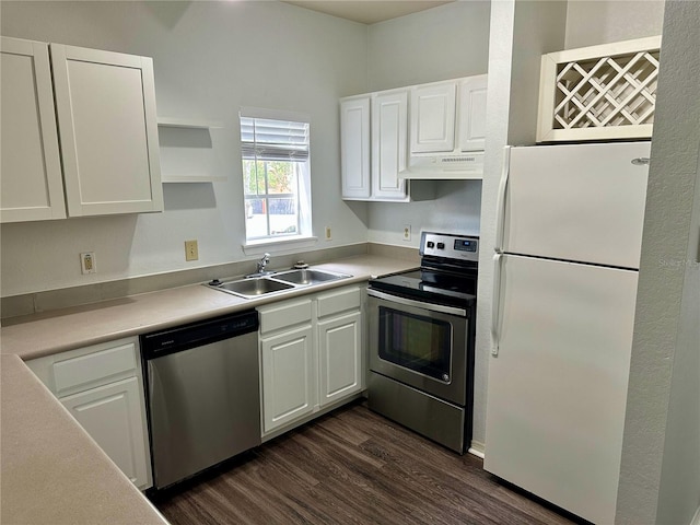 kitchen with dark hardwood / wood-style flooring, appliances with stainless steel finishes, sink, and white cabinets