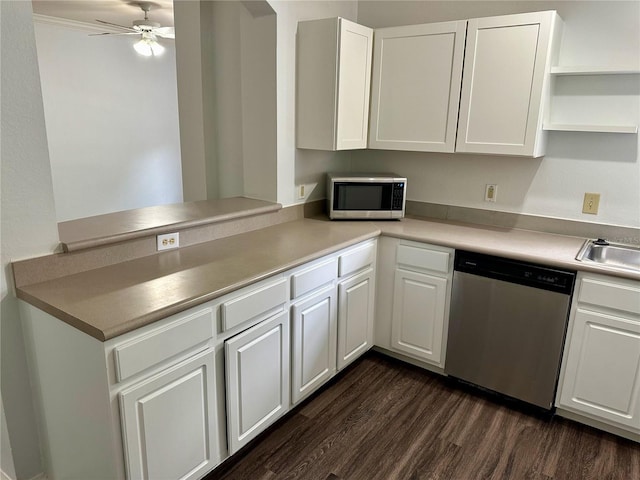 kitchen featuring dark wood-type flooring, kitchen peninsula, stainless steel appliances, white cabinets, and ceiling fan