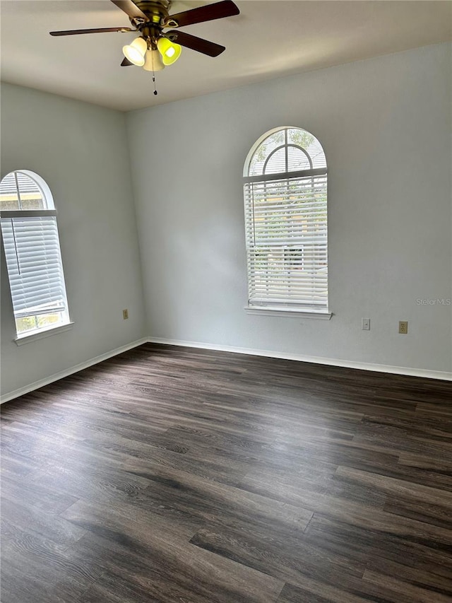 unfurnished room featuring ceiling fan and dark hardwood / wood-style flooring