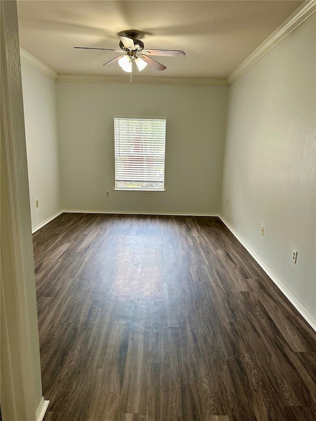 empty room featuring ornamental molding, dark wood-type flooring, and ceiling fan