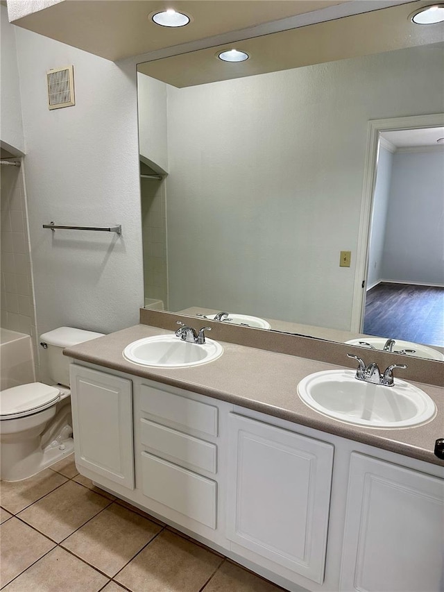 bathroom with vanity, toilet, and tile patterned floors