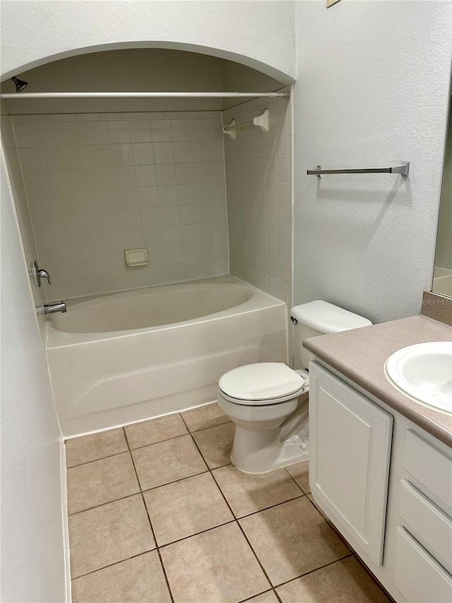 full bathroom with vanity, toilet, tile patterned flooring, and tiled shower / bath