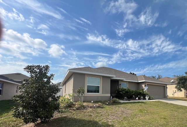 view of front facade with a garage and a front lawn