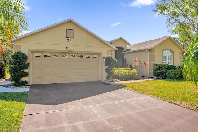 ranch-style house featuring a front lawn and a garage